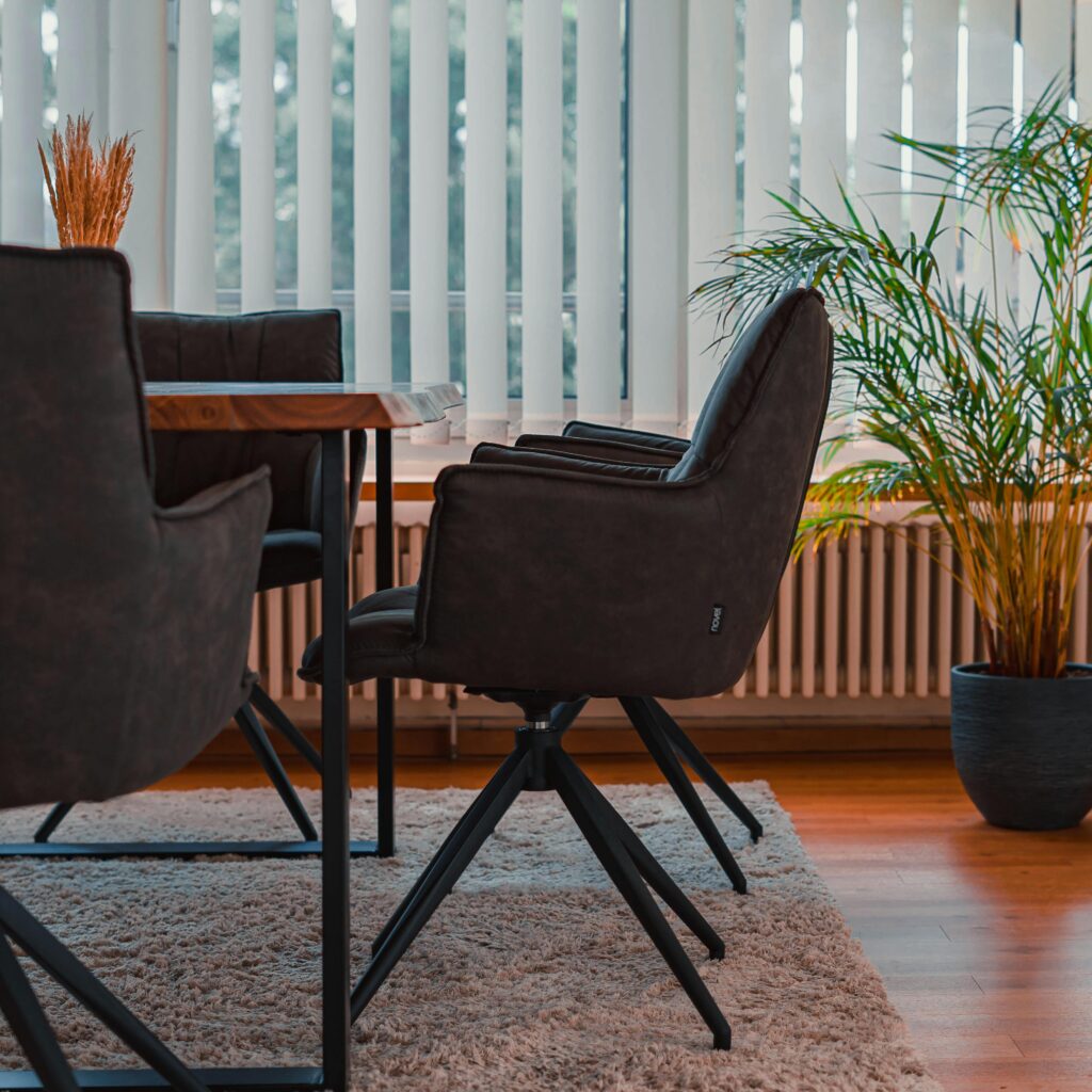 A stylishly designed conference room with modern chairs and potted plants.